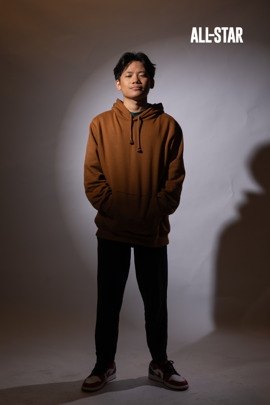 Filipino boy wearing hoodie, studio